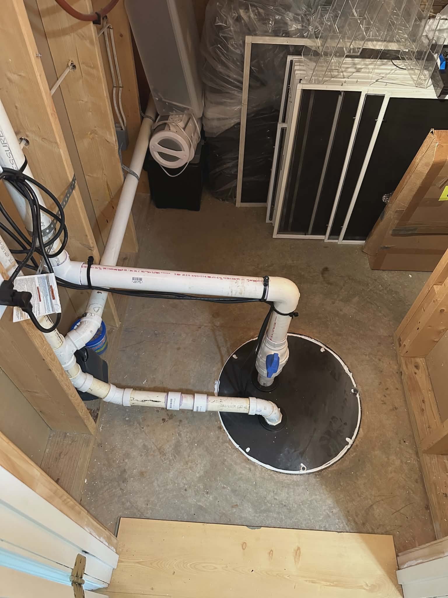 Sump pump installation in a residential crawlspace with discharge line connected