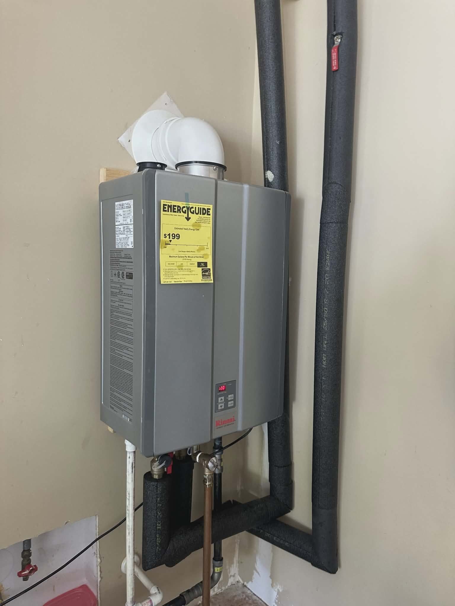 Tankless water heater installed on an interior wall with proper venting