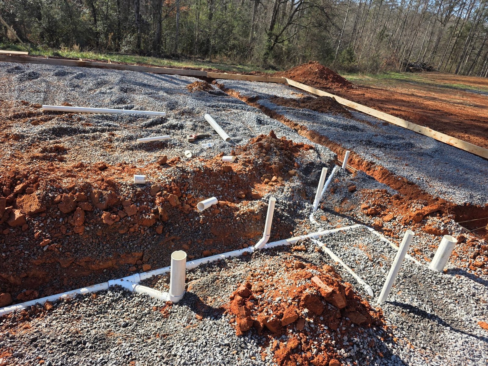 Foundation plumbing stub-outs roughed in on a new construction site in Yadkinville, NC
